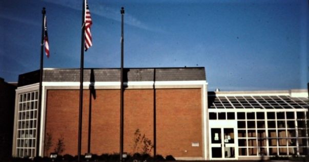 front of current library building with flags flying