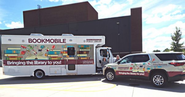 new bookmobile and new traverse with bright colors and library logo