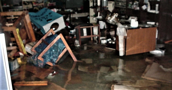 chairs and desks overturned in floodwater 