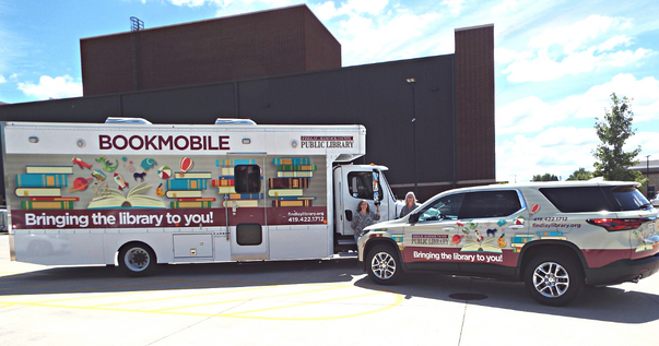 Kayleen and Lisa with outeach vehicles