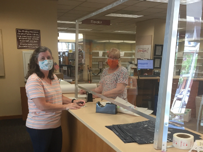 photo of two library workers with masks on