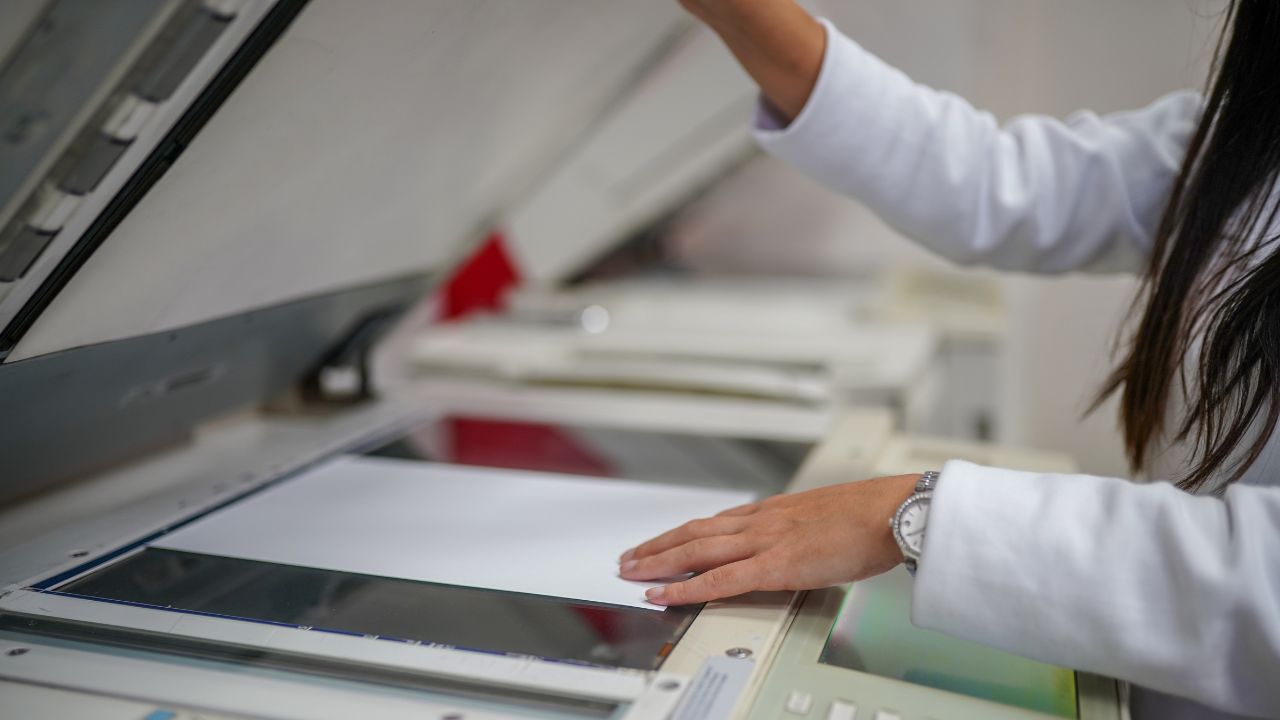 woman using machine to mack a copy of paper