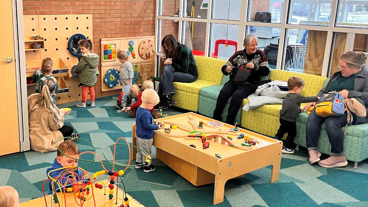 kids in early learning center with moms and grandmothers