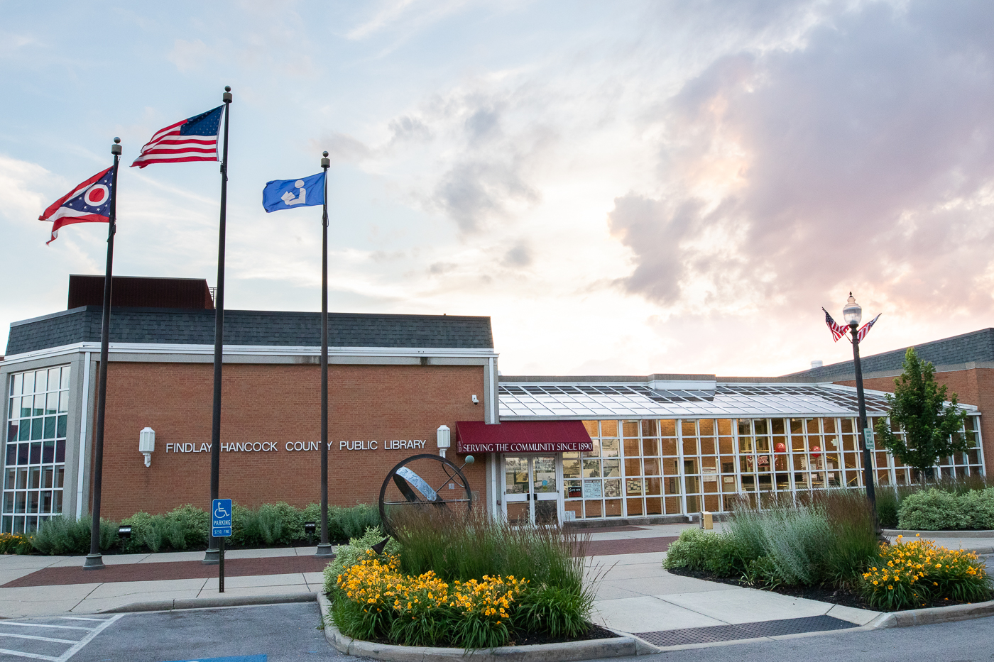 photo of library with yellow flowers out front