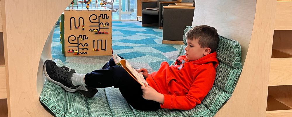 boy in nook reading a story