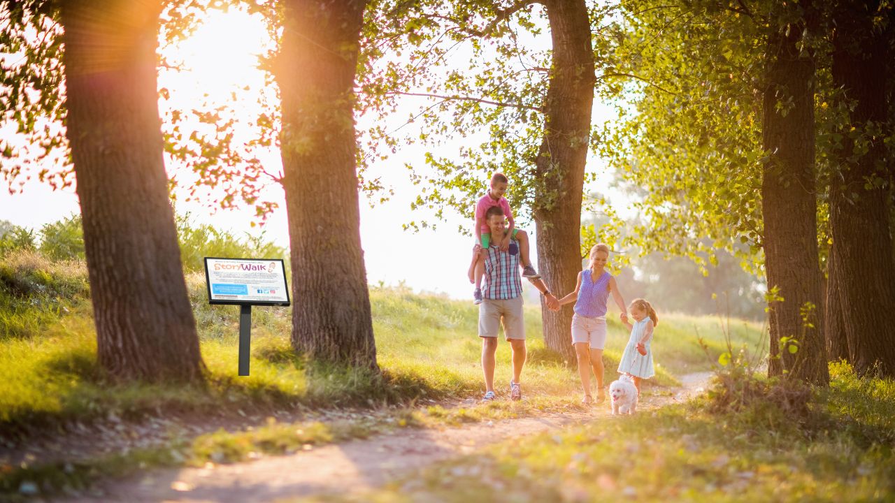 family walking down Storywalk path