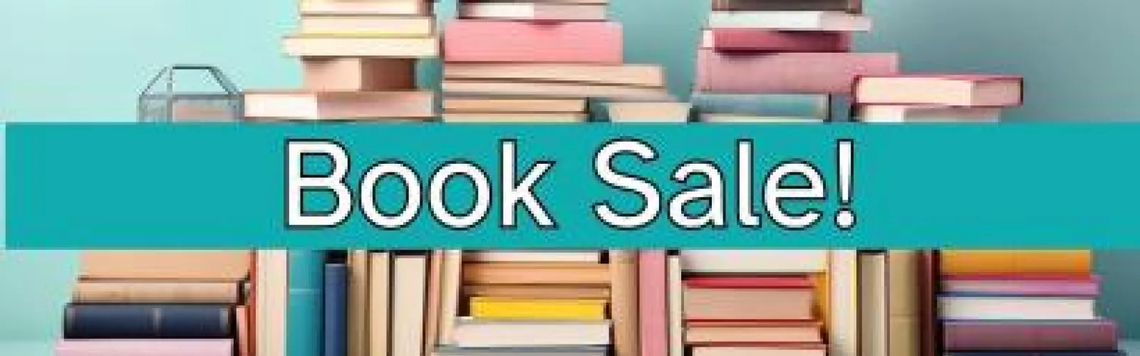 pile of colorful books with teal background